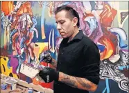  ?? OKLAHOMAN ARCHIVES] ?? Tulsa native Yatika Fields paints a mural in 2018 in Norman. He will paint a new landscape commission­ed by Oklahoma Contempora­ry for “Bright Golden Haze,” the opening exhibit at the arts center's new downtown home. [THE