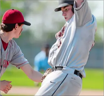  ?? SARAH GORDON/THE DAY ?? Fitch’s Hendrik Khoury, left, attempts to tag out Montville’s Seamus Barry at first base during a high school baseball game Thursday in Groton. Montville won 11-6.