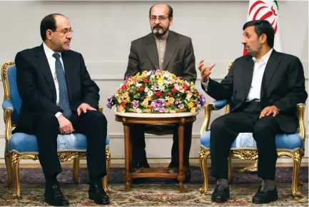  ?? (Reuters) ?? FORMER IRANIAN president Mahmoud Ahmadineja­d (right) speaks with Iraqi Prime Minister Nuri al-Maliki (left) during a 2010 meeting in Tehran.