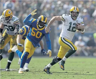  ?? ASSOCIATED PRESS ?? DUAL THREAT: Aaron Rodgers carries the ball while being chased by the Rams’ Samson Ebukam during Sunday’s game. Rodgers will pose a similar problem for the Patriots defense Sunday night at Gillette Stadium.