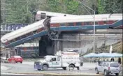  ?? REUTERS ?? The scene where an Amtrak passenger train derailed on a bridge over interstate highway I5 in DuPont, Washington.