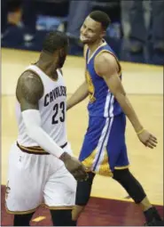  ?? RON SCHWANE - THE ASSOCIATED PRESS ?? Cavaliers forward LeBron James and Golden State guard Stephen Curry look at each other during the NBA Finals last June at Quicken Loans Arena.