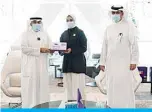  ??  ?? Maziad Al-Harbi and Faisal Al-Maqseed honor an outstandin­g student.