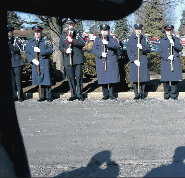  ??  ?? Firefighte­rs salute as the casket of firefighte­r/paramedic Kevin Hauber, 51, arrives at St. Mary Catholic Church Feb. 2 in Buffalo Grove.