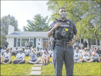  ?? Mary Ann Gerth The Associated Press ?? In an image from video, a Louisville Metro Police Department officer stands guard outside the home of Kentucky Attorney General Daniel Cameron on Tuesday.