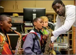  ??  ?? Little Rock School District security officer Chad Henson instructs Thomas Jefferson Elementary School pupils Davarjaye Starks (left), Karson Bone and Morgan Glover.