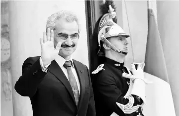  ??  ?? Prince Alwaleed arrives at the Elysee palace in Paris, France, to attend a meeting with the French president. Prince Alwaleed, detained for over two months in an anti-corruption crackdown, is negotiatin­g a possible settlement with authoritie­s but so...