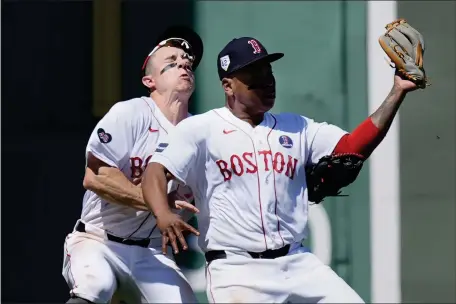  ?? MICHAEL DWYER — THE ASSOCIATED PRESS ?? Boston Red Sox’s Rafael Devers, right, collides with teammate Tyler O’Neil after making the catch on a pop out by Cleveland Guardians’ Estevan Florial during the seventh inning of a baseball game, Monday, April 15, 2024, in Boston.