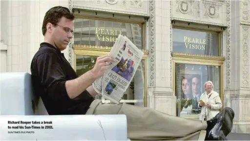  ?? SUN- TIMES FILE PHOTO ?? Richard Roeper takes a break to read his Sun- Times in 2001.