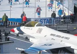  ?? Andy Cross, The Denver Post ?? An Air Force Thunderbir­ds F-16 sits on the field next to the ice during the Colorado Avalanche’s practice at Falcon Stadium.