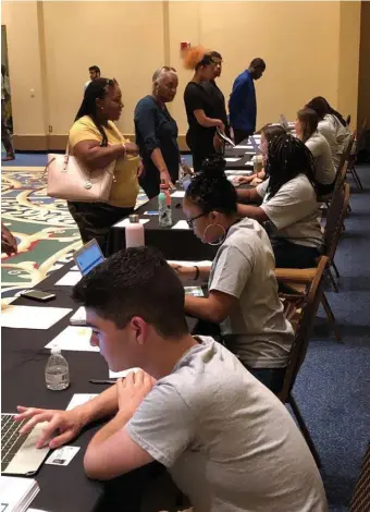  ?? AP FILE PHOTOS ?? HOPING FOR WORK: Detroit residents attend a job readiness event to pre-register to apply for jobs at a coming Fiat Chrysler assembly plant and another nearby facility operated by the automaker.