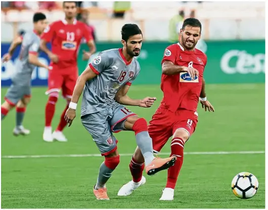  ??  ?? Eyes on theball: Persepolis’ Ahmad Nourollahi (right) vying for the ball with Al-Duhail’s Sultan al-Brake during the AFC Champions League quarterfin­als at the Azadi Stadium in Teheran on Monday. — AFP