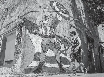  ?? FOTO PROFIMEDIA ?? Izrael se ubránil i díky USA. Na zdi jedné z telavivský­ch budov je k vidění Joe Biden coby komiksová postava Captain America.