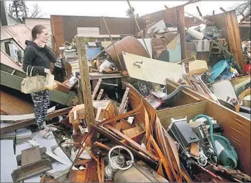  ?? Pedro Portal Miami Herald ?? IN PANAMA CITY, Fla., Haley Nelson stands amid the ruins of her family properties after Hurricane Michael made landfall nearby with 155-mph winds, almost strong enough to be a Category 5 storm.