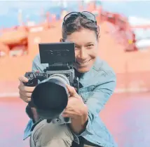  ??  ?? Above: Cinematogr­apher, scientist, sailor, Frederique Olivier in front of the Aurora Australis, a ship on which she has spent a lot of time during her many expedition­s to and from the icy wonders of Antarctica. Below: Setting up her equipment with an...