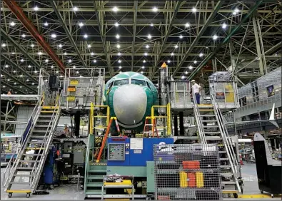  ?? AP/TED S. WARREN ?? A Boeing 737 Max airplane is assembled at a Boeing facility in Renton, Wash., in this file photo. Demand for commercial aircraft fell 27.1 percent in February, the U.S. said Thursday.