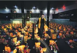  ??  ?? A MAN sorts through donations for families in need in the holy city of Najaf amid the COVID-19 pandemic that has forced religious communitie­s to adjust.