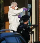  ?? ?? Forensic officers at the murder scene