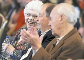  ?? Jessie Wardarski/Post-Gazette ?? Wife of the late Mr. Rogers, Joanne Rogers, left, smiles toward friends and former cast members David Newell, center, and Joe Negri, right.