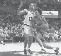  ?? DARRON CUMMINGS/AP ?? Villanova guard Jordan Longino (15) drives to the basket past Butler forward D.J. Hughes (0) during the second half on Saturday in Indianapol­is.