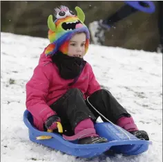  ??  ?? Emily Cobbe sledding down the snow slopes on Bray Head.