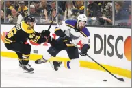  ?? Michael Dwyer / Associated Press ?? The Boston Bruins’ David Krejci, left, checks the St. Louis Blues’ Zach Sanford off his skates during the third period in Game 5 of the Stanley Cup Final on Thursday in Boston.