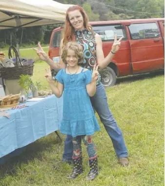  ?? COURTESY PHOTOS ?? O the Grid Farm Manager Elizabeth Melson and her daughter at the Hemp Harvest Festival in October 2020.