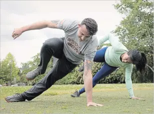  ??  ?? Nicole Tsong learns how to do the “lizard walk” with trainer Kyle Long. At left is the advanced “lizard walk. “