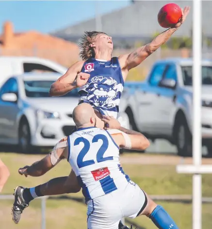  ?? Picture: GLENN HAMPSON ?? Broadbeach’s Thomas Betson soars over Mt Gravatt’s Matthew Pearce.