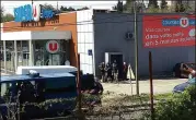  ?? NEWSFLARE / TARBOURIEC­H ROSELINE ?? French police gather Friday at a Super U supermarke­t in Trèbes, France, where an armed extremist took hostages before police stormed the grocery, killing the 26-year-old man.