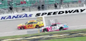  ?? Chris Graythen, Getty Images ?? Joey Logano, left, crosses the finish line to win the Hollywood Casino 400 at Kansas Speedway on Sunday in Kansas City, Kan.