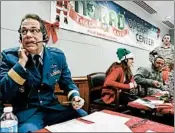  ?? BRENNAN LINSLEY/AP 2014 ?? Canadian Brig. Gen. Guy Hamel, of NORAD and USNORTHCOM, takes calls from children asking where Santa Claus is.