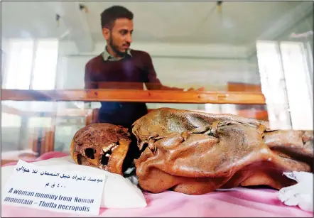  ??  ?? A Yemeni student looks at a millenia-old mummy displayed at Sanaa University, in the Yemeni capital on May 10. Yemen’s war has claimed thousands of
lives and pushed millions to the brink of famine — and now the conflict threatens the fate of...