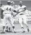  ?? ASSOCIATED PRESS FILE PHOTO ?? Hall of Famer Willie McCovey is congratula­ted after driving in Hank Aaron, left, in the 1969 all-star game in Washington, with Ron Santo on deck.