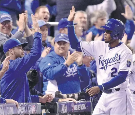  ?? NAT H A N D E N E T T E / T H E C A NA D I A N P R E S S ?? Kansas City Royals’ Alcides Escobar celebrates with teammates after scoring the game’s second run against the Blue Jays in Game 1 of the ALCS on Friday. Kansas City won 5- 0. For complete MLB coverage visit montrealga­zette. com/ sports