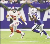  ?? Darron Cummings / Associated Press ?? Giants running back Saquon Barkley eludes Colts cornerback Kenny Moore in a Dec. 23 game.