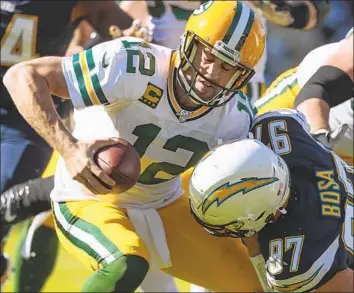  ?? Robert Gauthier Los Angeles Times ?? JOEY BOSA tackles Green Bay’s Aaron Rodgers, who was held in check by the Chargers until late in the game. Bosa and teammate Melvin Ingram each had 11⁄2 sacks, helping to hold Rodgers to 161 yards passing.