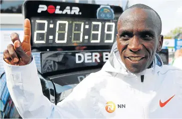  ?? /AFP (See Back Page) ?? All-time great: Kenya’s Olympic champion Eliud Kipchoge celebrates winning the Berlin Marathon and setting a new world marathon record on Sunday. He pulverised the record with a blistering run, slicing a staggering 78 seconds off the previous best to land the one major running crown that has eluded him.