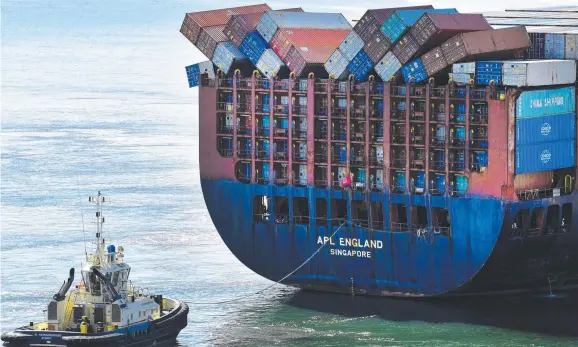  ?? Picture: AAP IMAGE ?? ROUGH TRIP: Fallen shipping containers can be seen on the Singapore-flagged container ship
APL England as she docks at the Port of Brisbane yesterday.