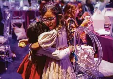  ?? ?? Ella Chandna hugs Rylee Wolfe during a luncheon at the Zellerbach Rehearsal Hall before the San Francisco Ballet’s “Nutcracker” performanc­e.