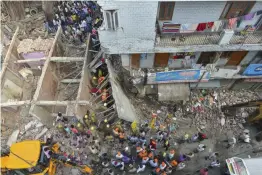  ?? — SONDEEP SHANKAR, PTI ?? NDRF personnel carry out rescue operations after a four- storey building collapsed at Ashok Vihar in Northwest Delhi on Wednesday.