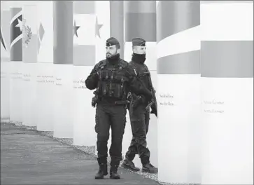  ?? Laurent Cipriani
Associated Press ?? FRENCH POLICE patrol outside the main entrance of the climate change conference, which opens Monday.