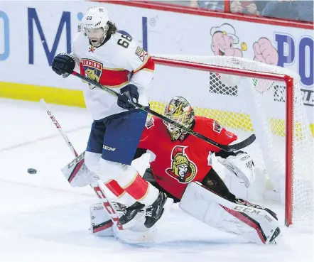  ?? — THE CANADIAN PRESS ?? Florida forward Jaromir Jagr jumps out of the way of a shot on Ottawa goaltender Mike Condon during the third period Saturday in Ottawa. The Senators won, 2-0.