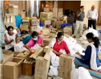  ??  ?? Judges and lawyers prepare relief material at the Kerala High Court premises in Kochi on Wednesday. — AP