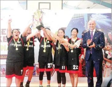  ?? CHHORN NORN ?? Legends players celebrate with the trophy after they winning the CamEd Women’s Basketball Cup during the CamEd Women’s Futsal Tournament 2022.