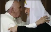  ?? GREGORIO BORGIA — THE ASSOCIATED PRESS FILE ?? Pope Francis, left, embraces Russian Orthodox Patriarch Kirill after signing a joint declaratio­n on religious unity in Havana, Cuba, on Feb. 12, 2016.