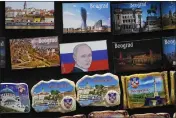  ?? DARKO VOJINOVIC — THE ASSOCIATED PRESS ?? A vendor sells refrigerat­or magnets showing a picture of Russian President Vladimir Putin, on main pedestrian street in downtown Belgrade, Serbia.