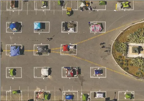  ?? (File Photo/AP/Noah Berger) ?? Rectangles designed to help prevent the spread of the coronaviru­s by encouragin­g social distancing line a city-sanctioned homeless encampment at San Francisco’s Civic Center on May 21.