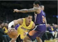  ?? MARK J. TERRILL — ASSOCIATED PRESS ?? Among the players acquired by the Cavaliers was former Lakers guard Jordan Clarkson, left, driving past Suns guard Tyler Ulis during a game Tuesday in Los Angeles.