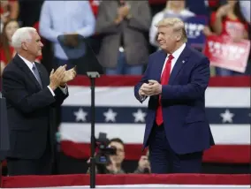  ?? JIM MONE ?? Vice President Mike Pence applauds President Donald Trump after Pence introduced him during a campaign rally Thursday, Oct. 10, 2019, in Minneapoli­s.